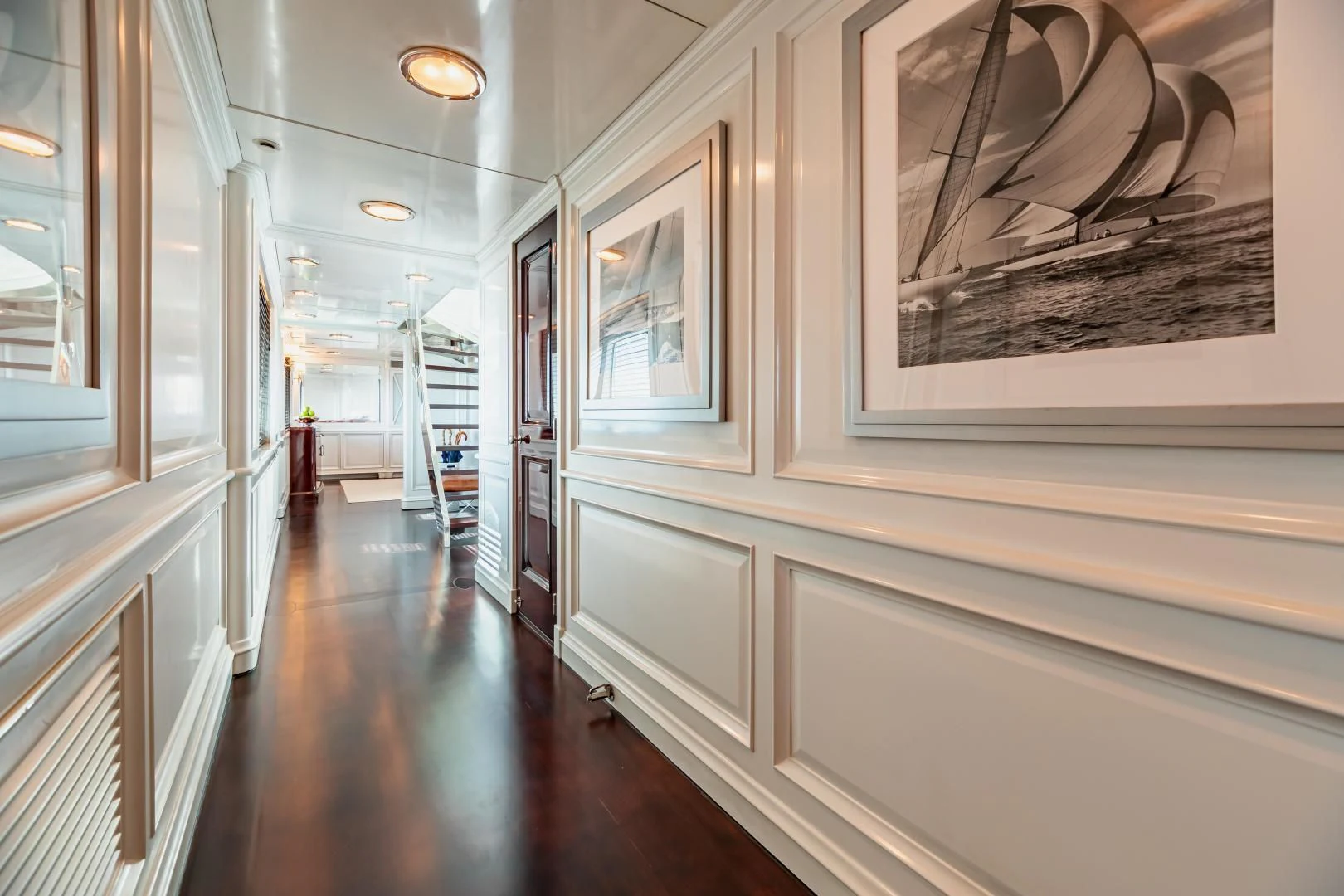 a hallway with a painting on the wall aboard EXPLORA Yacht for Sale