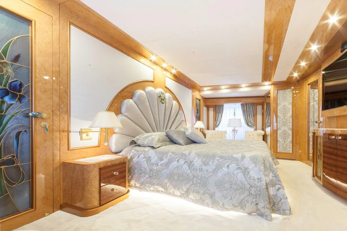 a bed with a white comforter aboard DUCHESSA Yacht for Sale