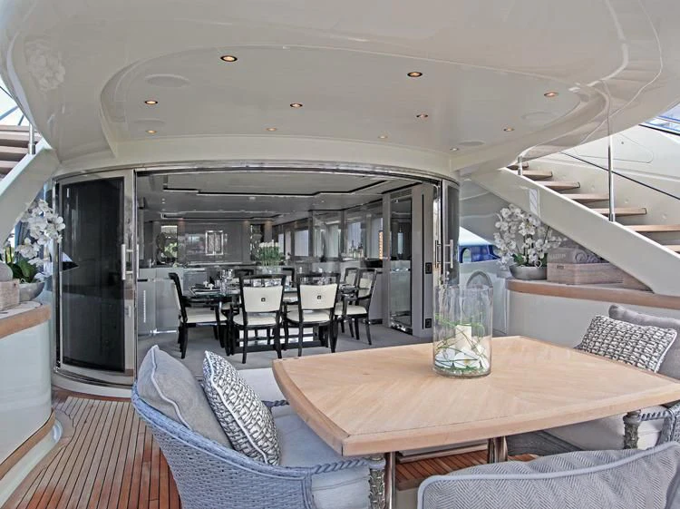 a large dining room with a large glass table and chairs aboard SEALYON Yacht for Sale