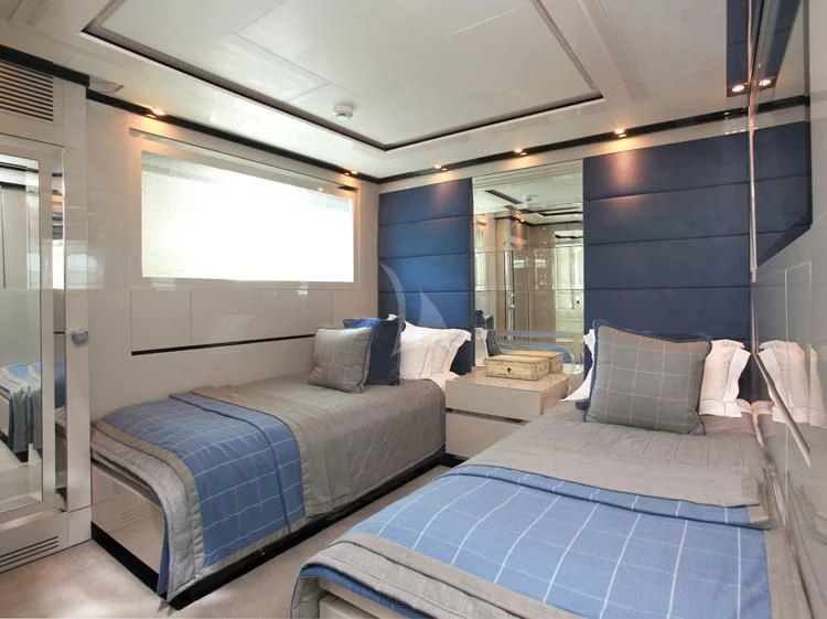 a room with a bed and a mirror aboard SEALYON Yacht for Sale
