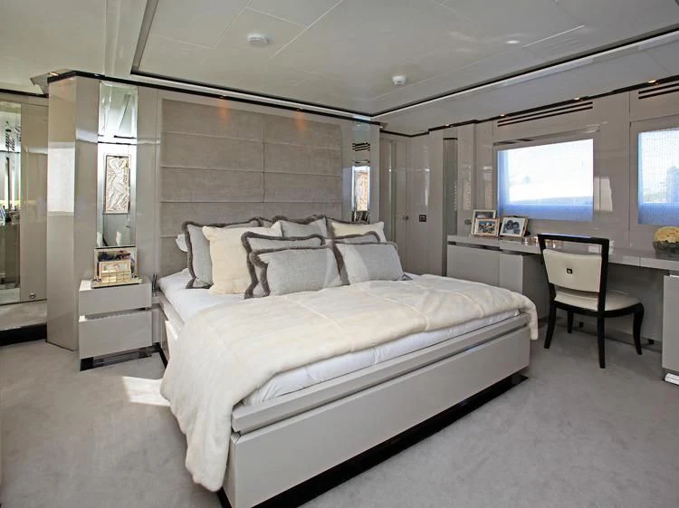 a bedroom with a bed and desk aboard SEALYON Yacht for Sale