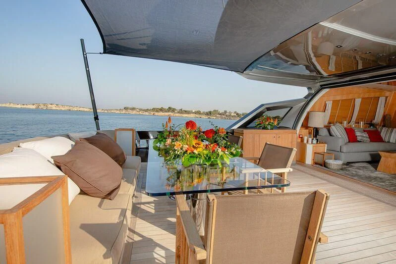 a boat with a table and chairs aboard ARION TERCERO Yacht for Sale