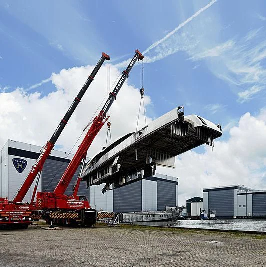 a crane lifting a container aboard AQUAMARINE X Yacht for Sale
