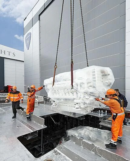 a group of men wearing orange vests and hard hats working on a white object aboard AQUAMARINE X Yacht for Sale