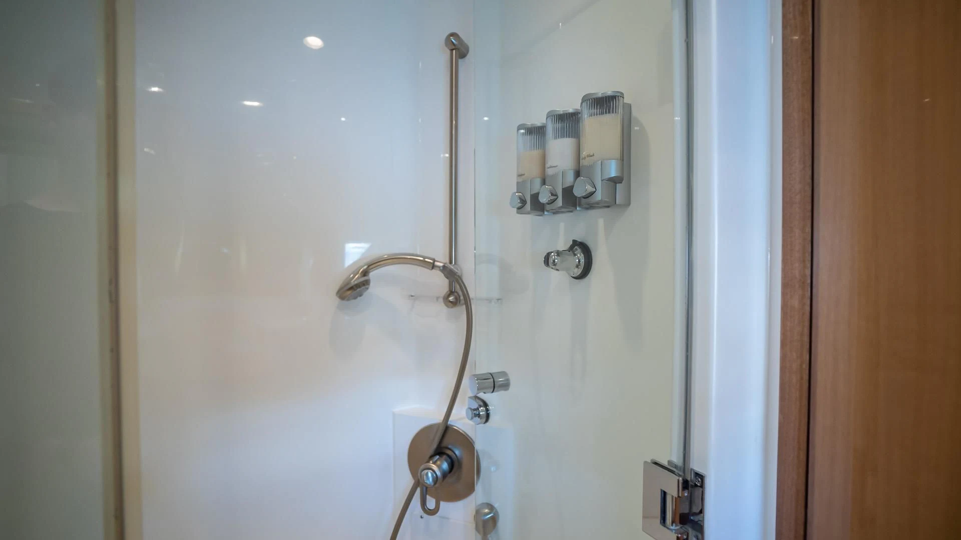 a white bathtub with a shower head and a metal faucet aboard FULL HOUSE Yacht for Sale