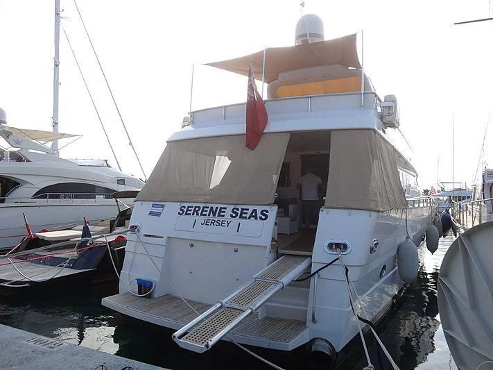 a boat docked at a pier aboard SERENE SEAS Yacht for Sale