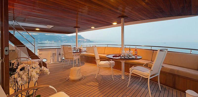 a room with tables and chairs aboard SHAHA Yacht for Sale