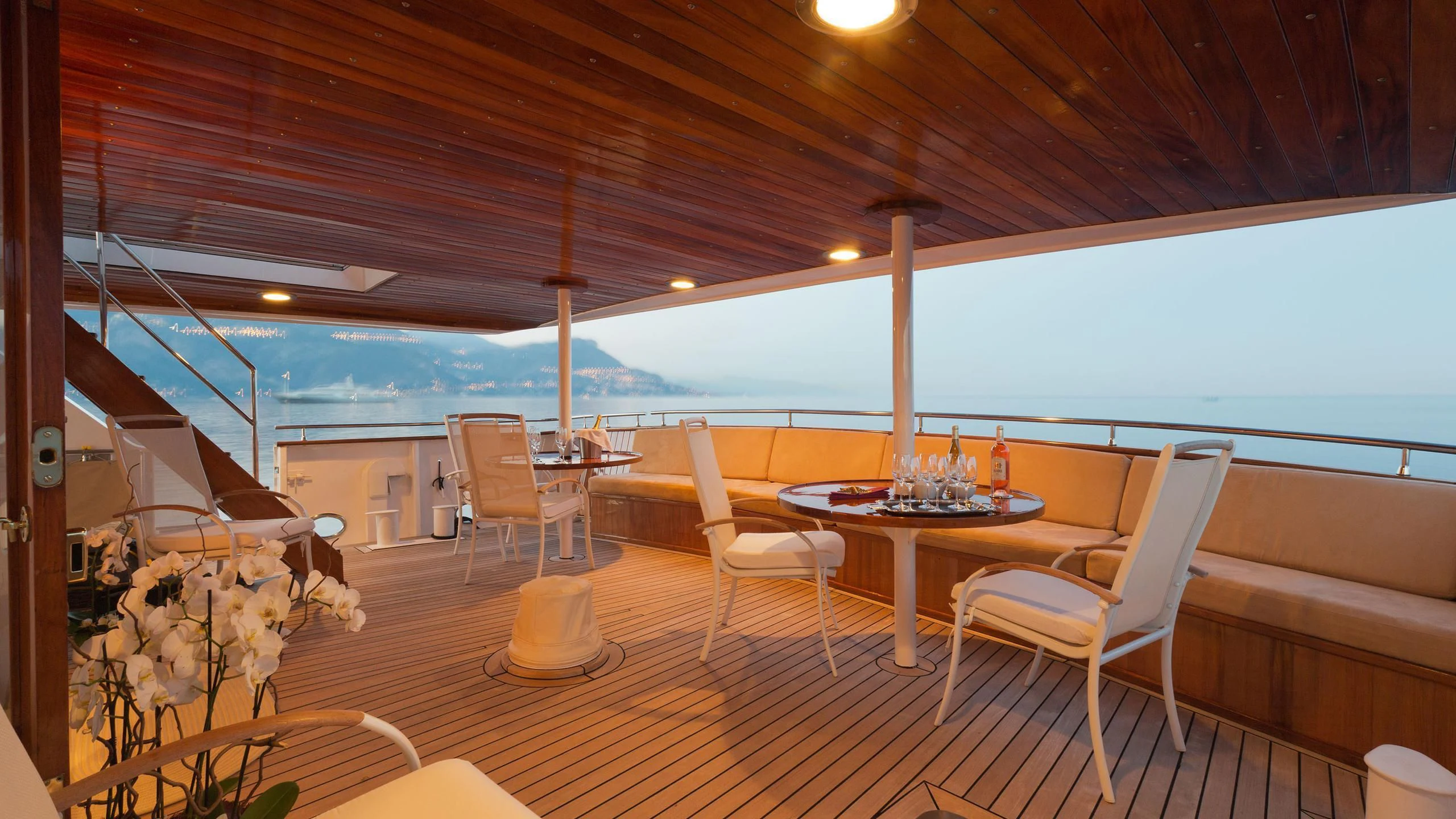 a table and chairs on a deck aboard SHAHA Yacht for Sale