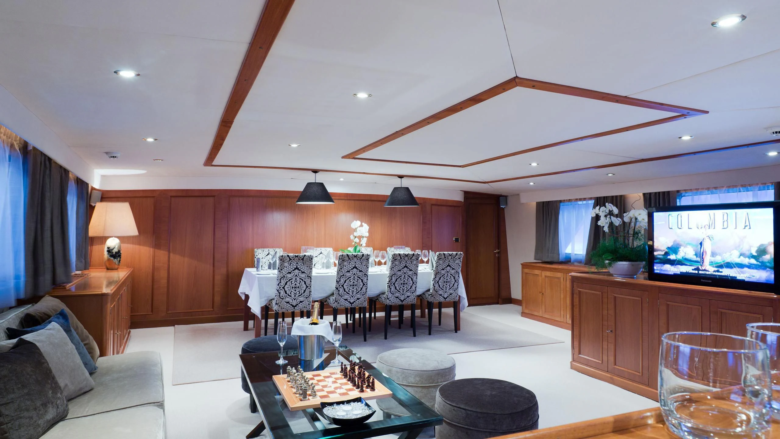 a living room with a large screen aboard SHAHA Yacht for Sale