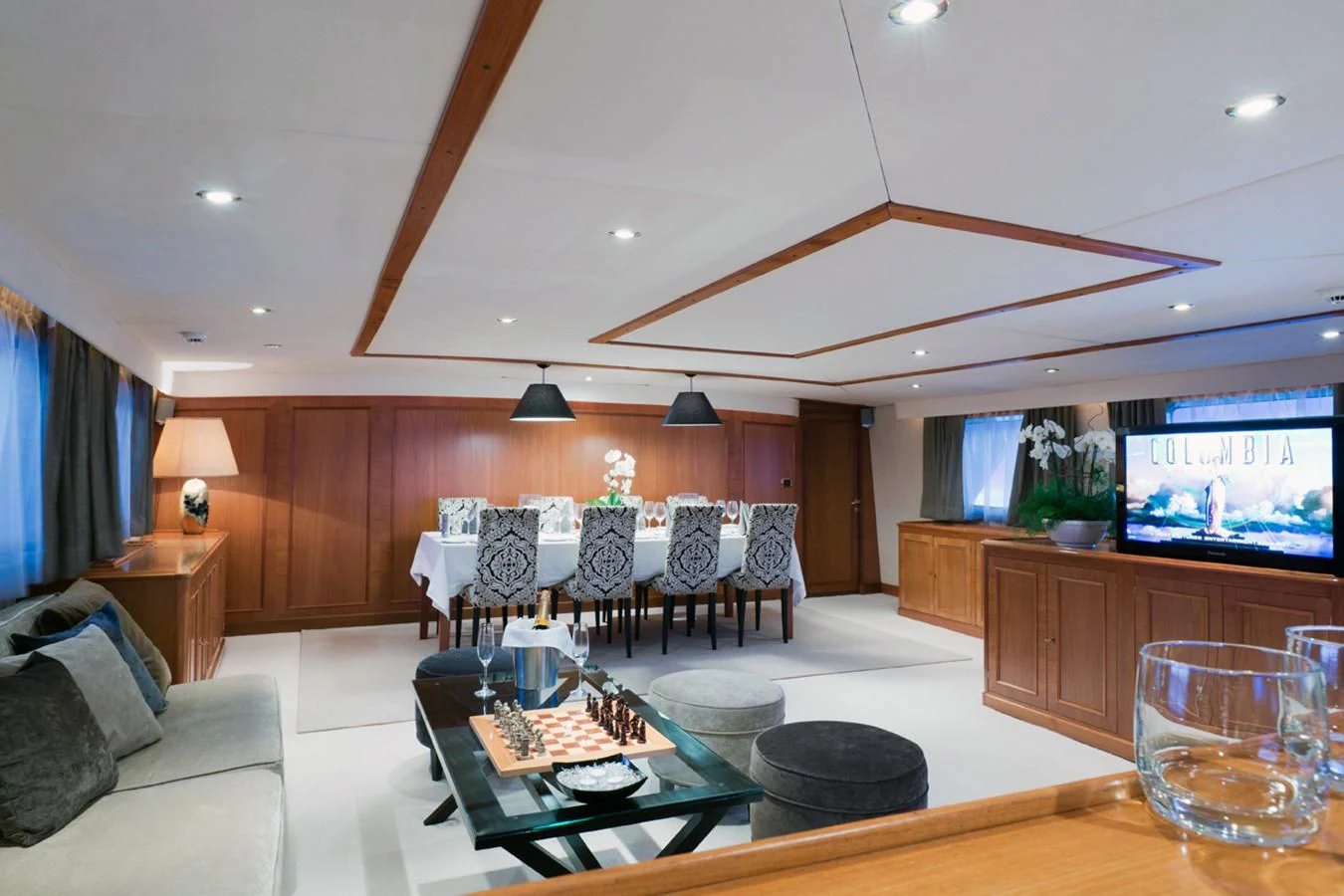 a living room with a large screen aboard SHAHA Yacht for Sale