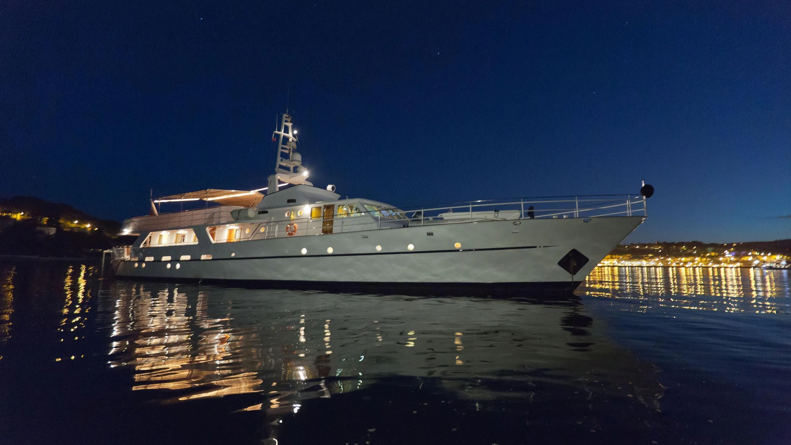 a large ship at night aboard SHAHA Yacht for Sale