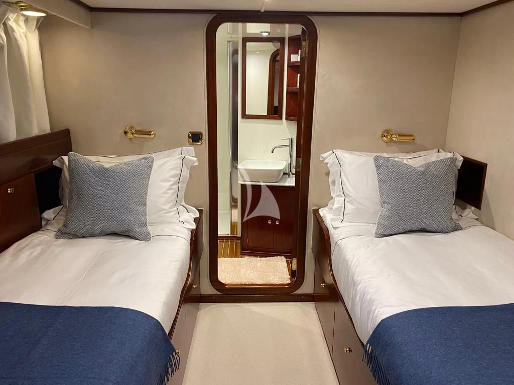 a room with two beds aboard SHAHA Yacht for Sale