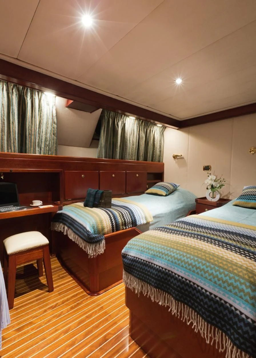 a room with two beds aboard SHAHA Yacht for Sale