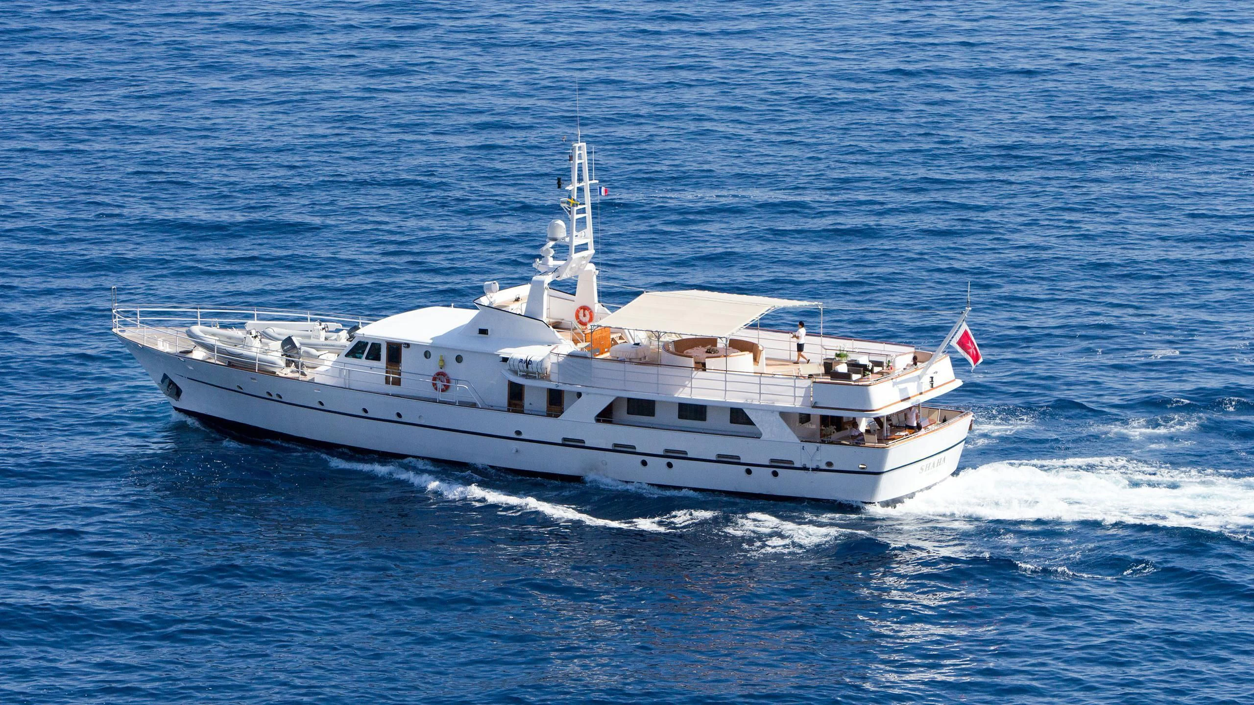 a white boat on the water aboard SHAHA Yacht for Sale