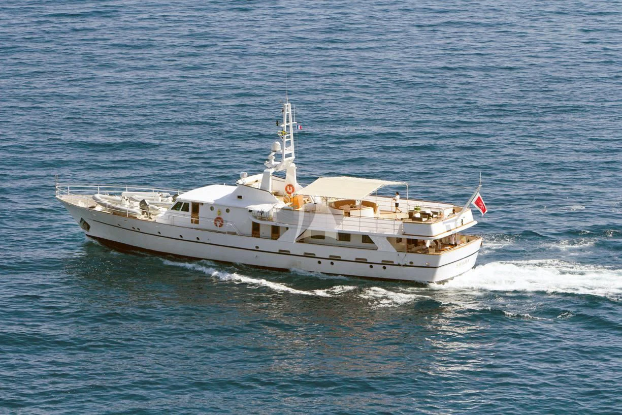 a large white boat on the water aboard SHAHA Yacht for Sale