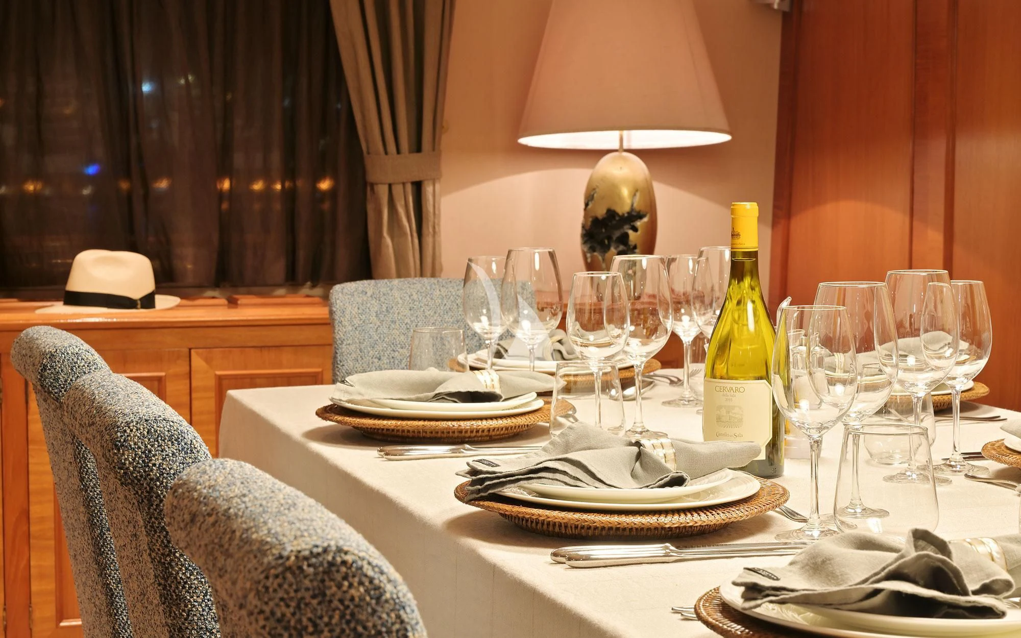 a table with wine glasses and plates aboard SHAHA Yacht for Sale