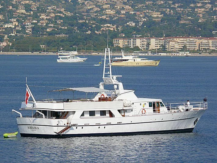 a large white boat in the water aboard SHAHA Yacht for Sale
