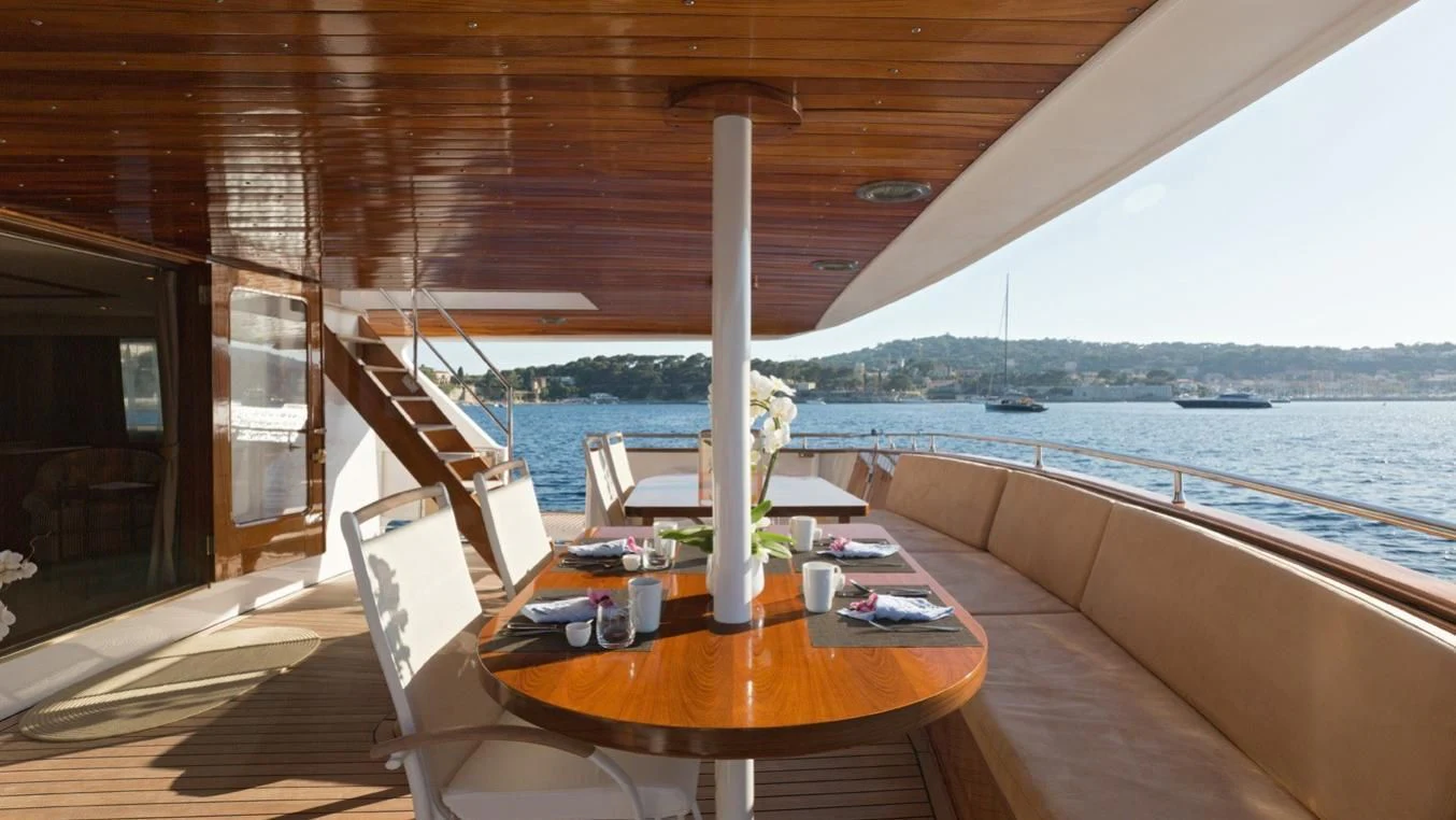 a table on a deck aboard SHAHA Yacht for Sale