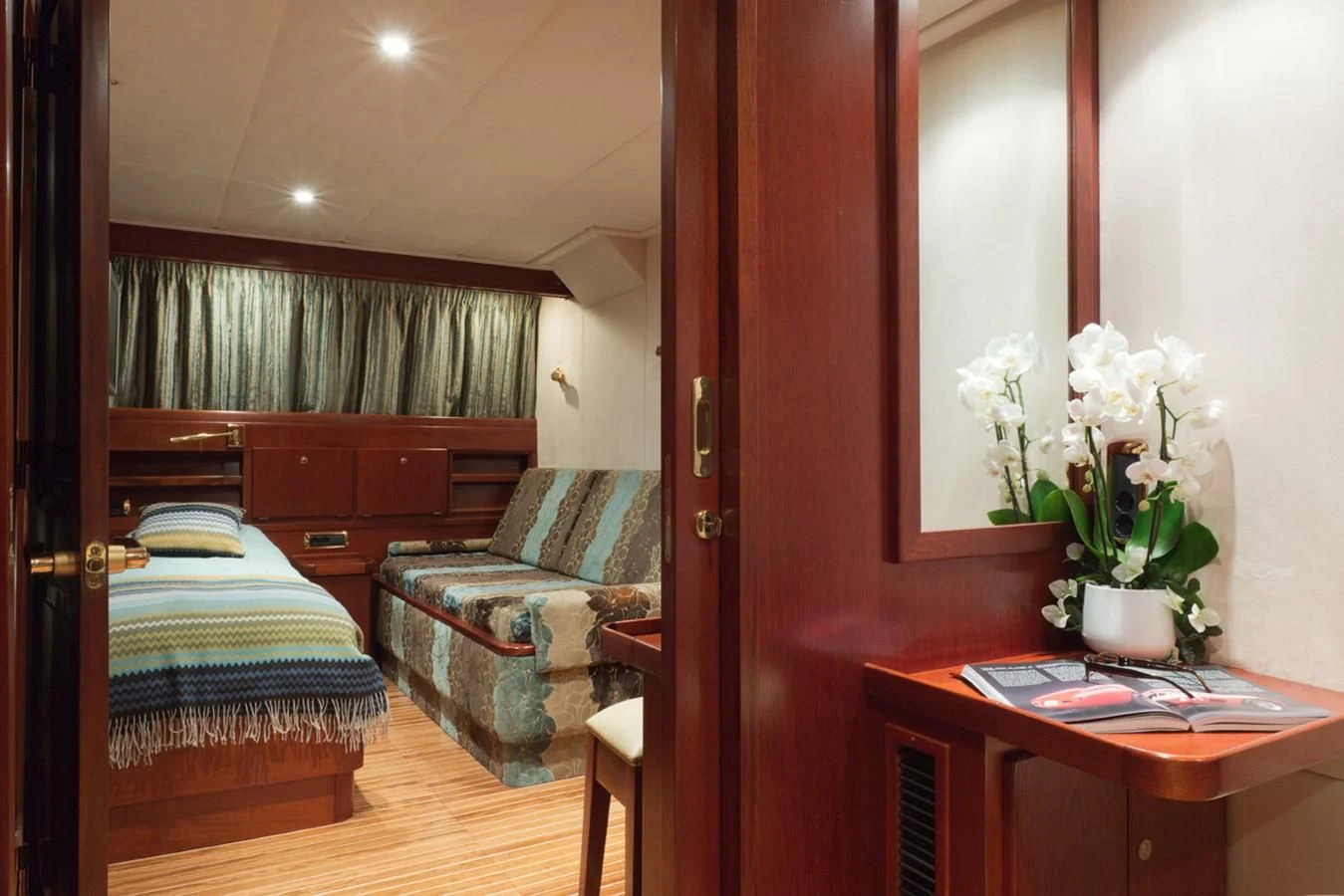 a room with a bed and a chair aboard SHAHA Yacht for Sale