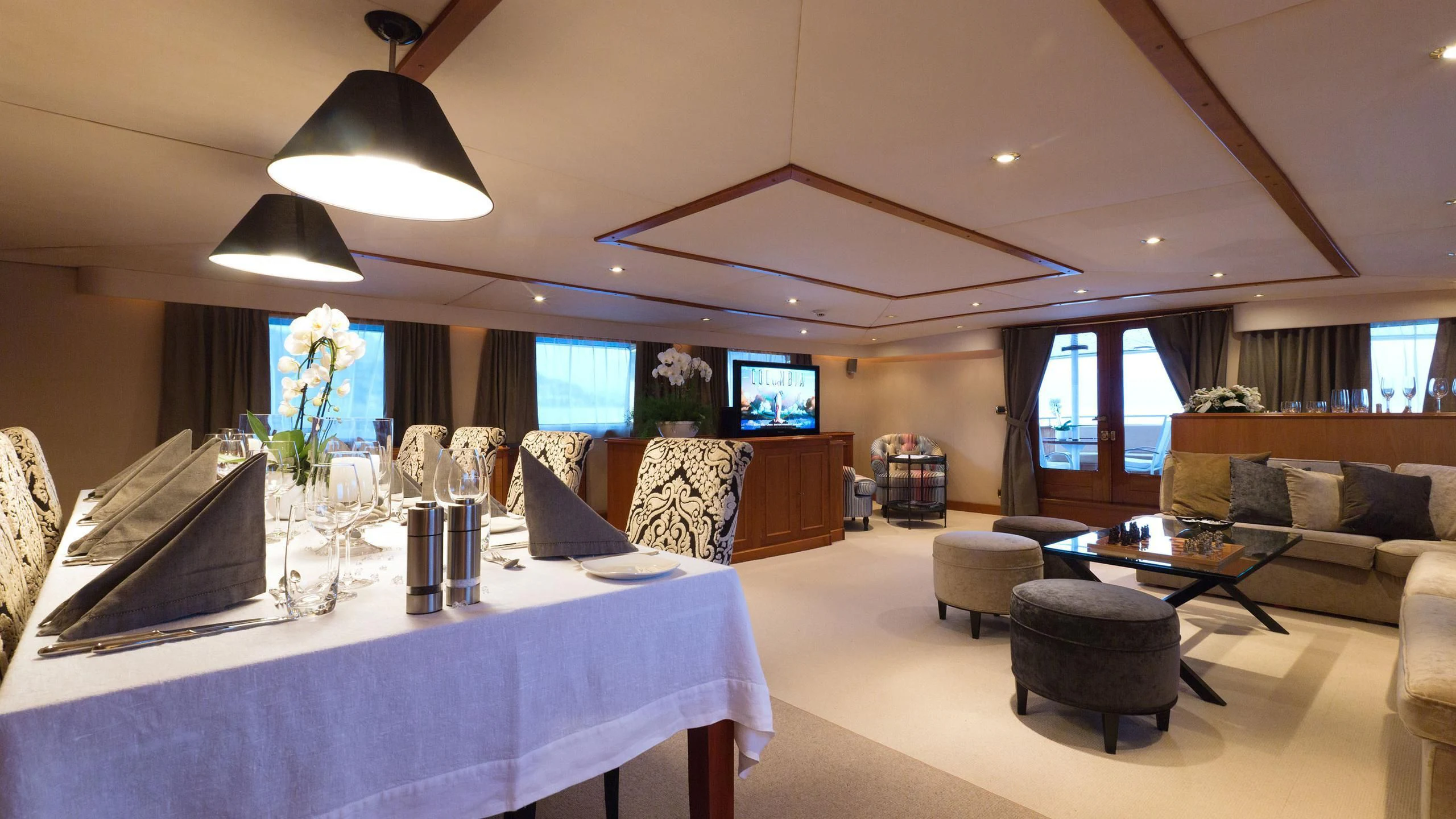 a large living room with a large table and a large white table aboard SHAHA Yacht for Sale