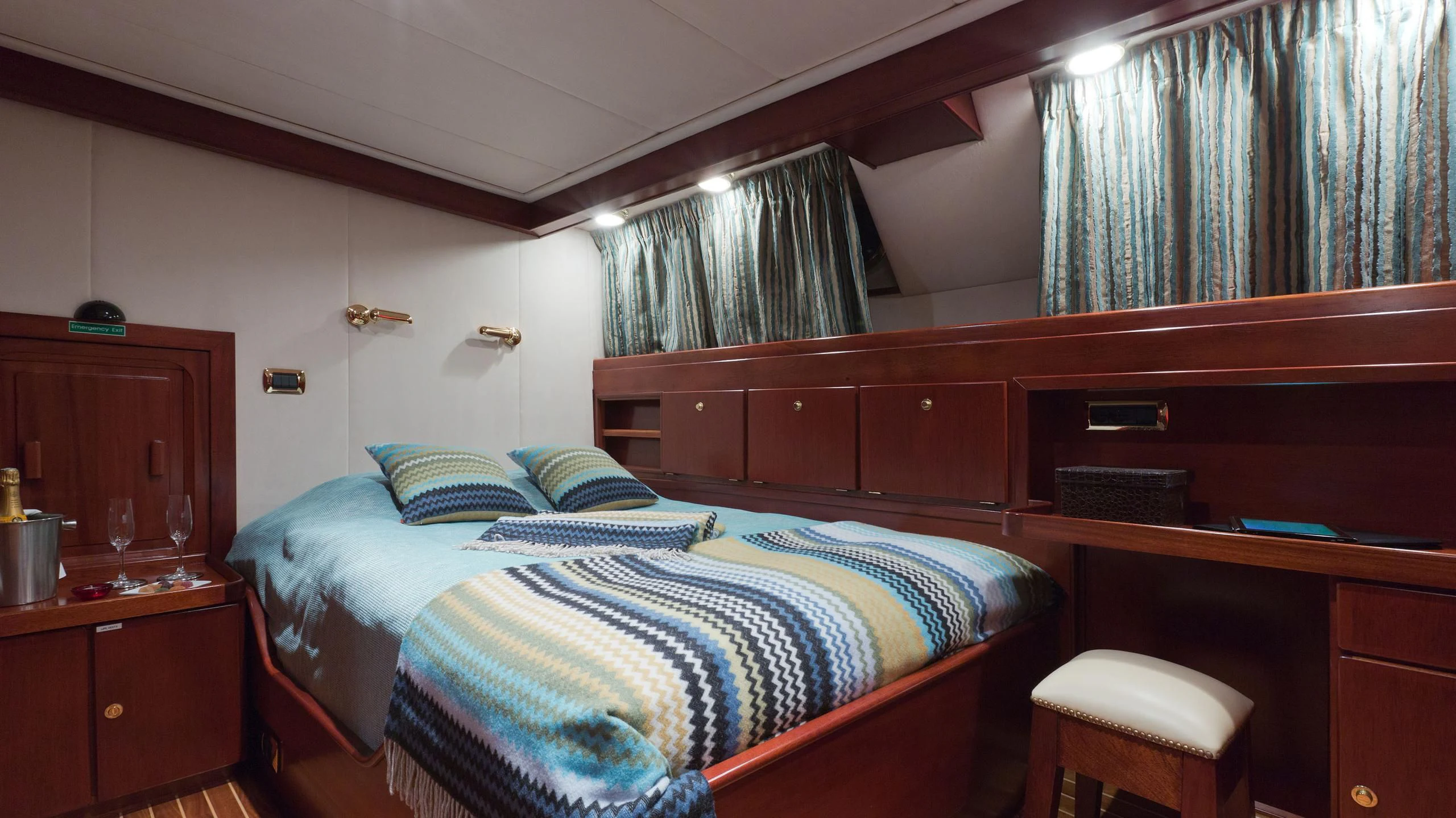 a bedroom with a bed and desk aboard SHAHA Yacht for Sale
