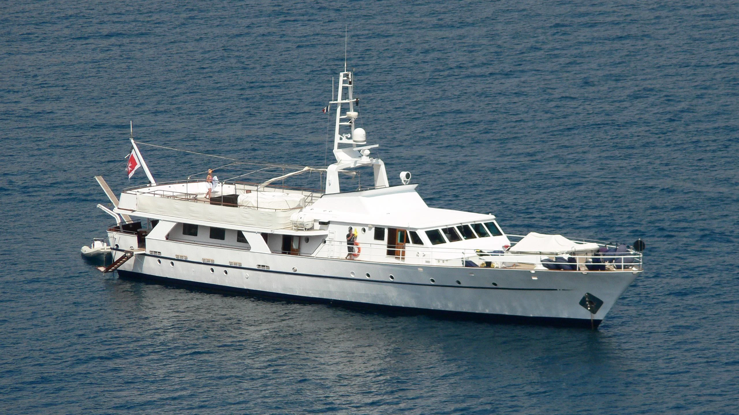 a large white boat in the water aboard SHAHA Yacht for Sale