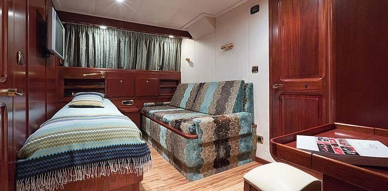 a bedroom with a bed and a desk aboard SHAHA Yacht for Sale