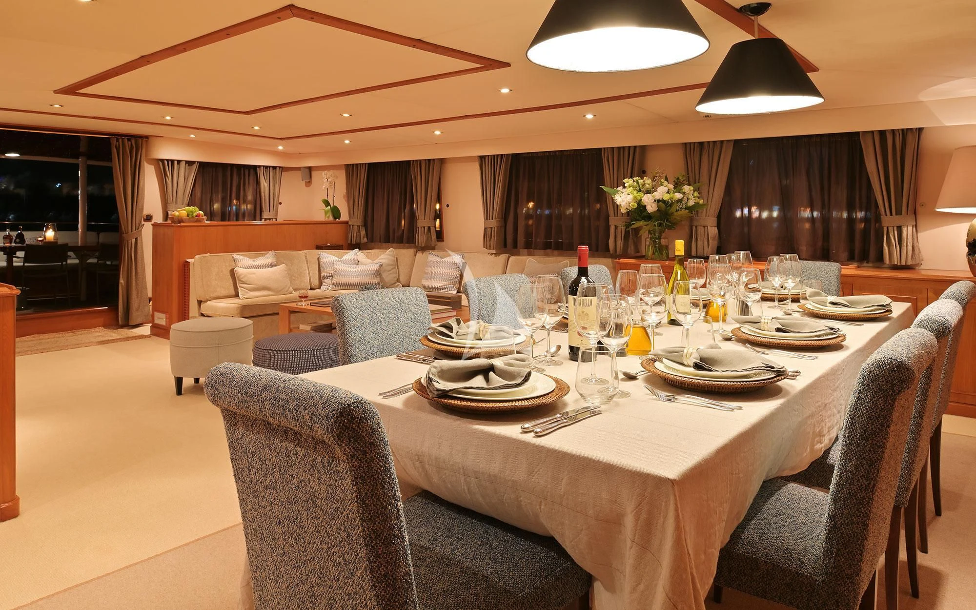 a large dining table with plates and glasses on it aboard SHAHA Yacht for Sale