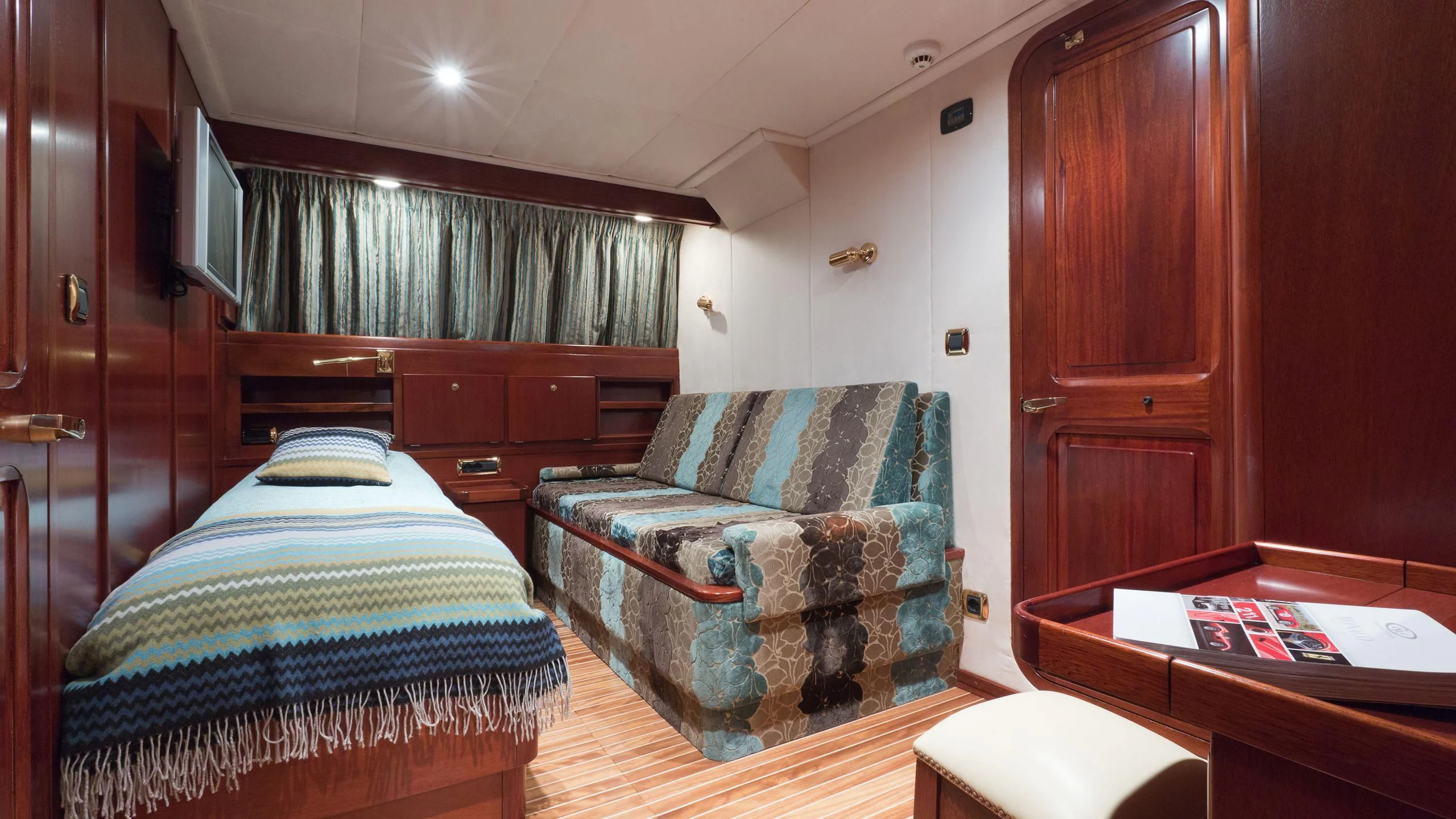 a bedroom with a bed and a couch aboard SHAHA Yacht for Sale