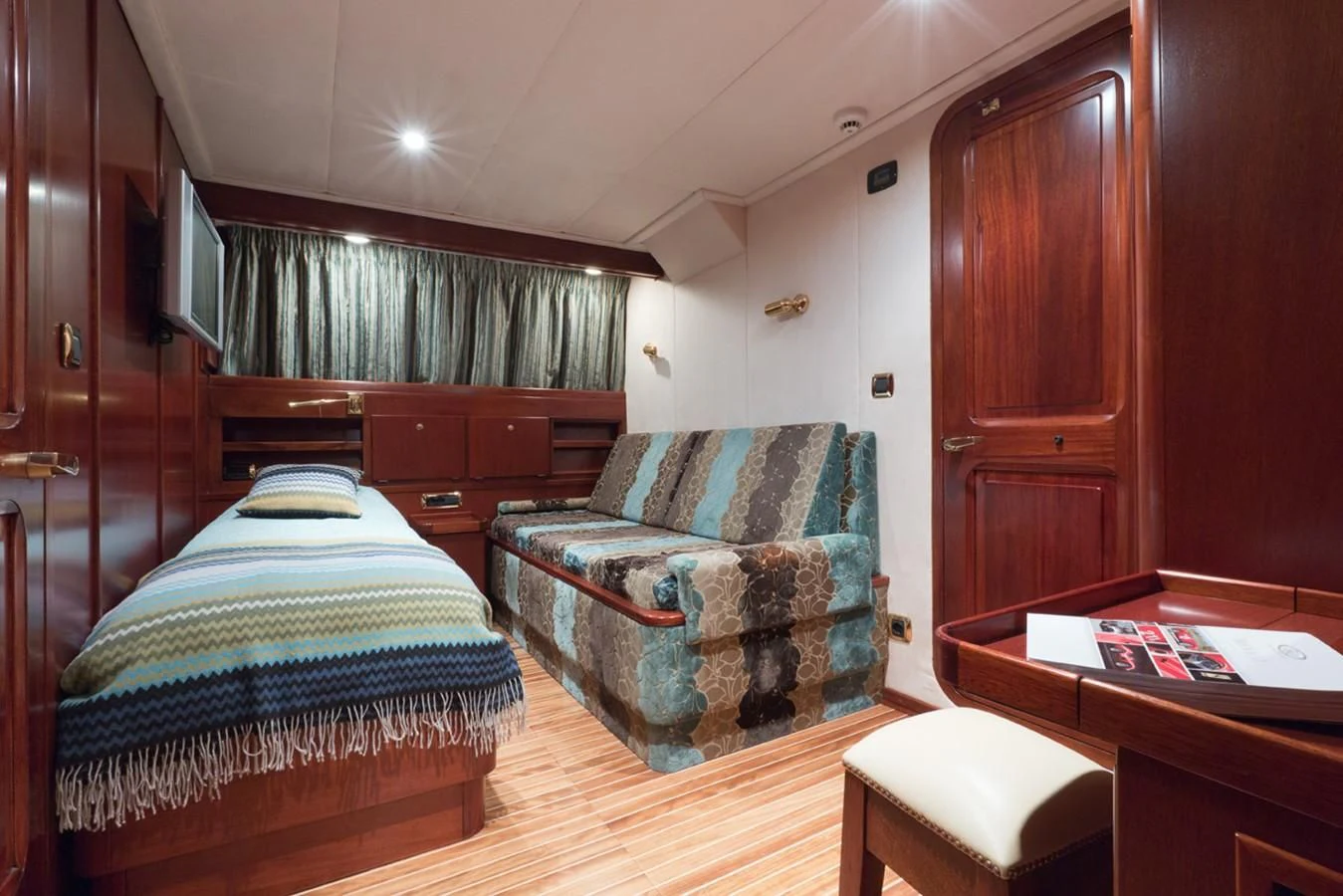 a bedroom with a couch and a bed aboard SHAHA Yacht for Sale