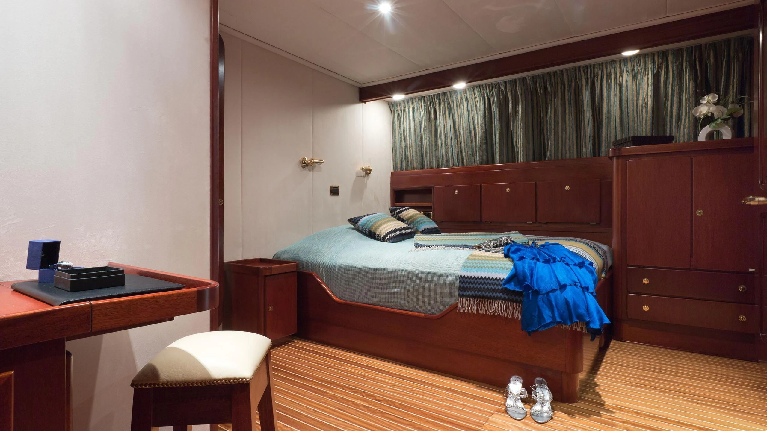 a bedroom with a bed and desk aboard SHAHA Yacht for Sale