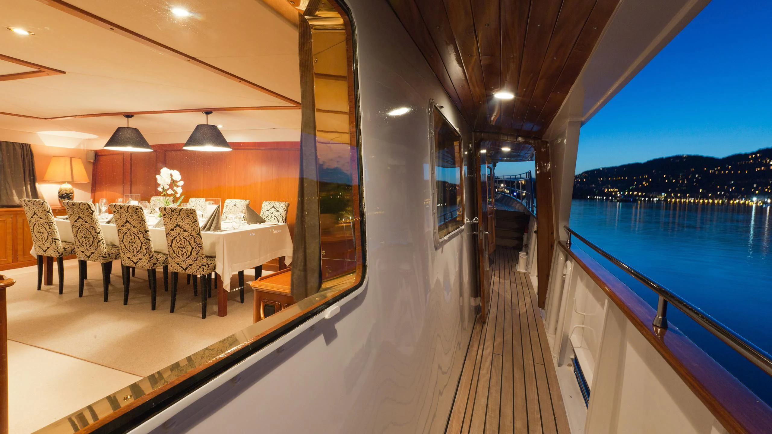 a boat with tables and chairs aboard SHAHA Yacht for Sale