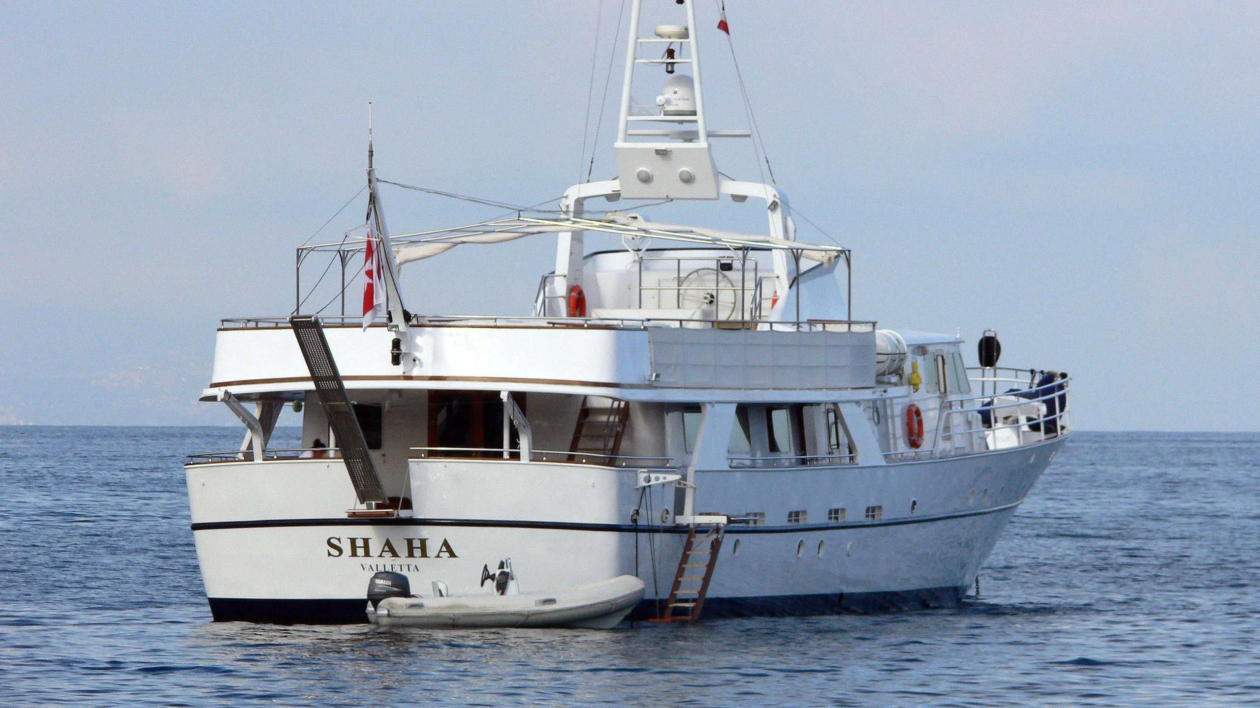 a white boat in the water aboard SHAHA Yacht for Sale