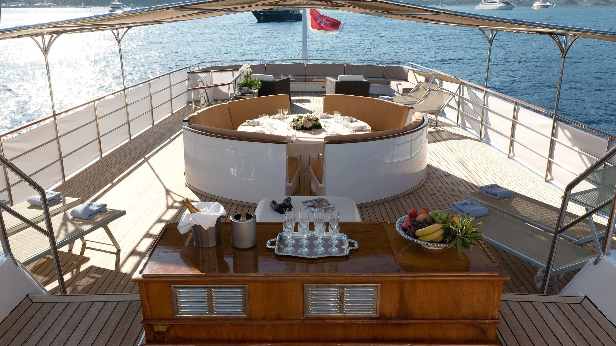a table with a bowl of fruit on it aboard SHAHA Yacht for Sale