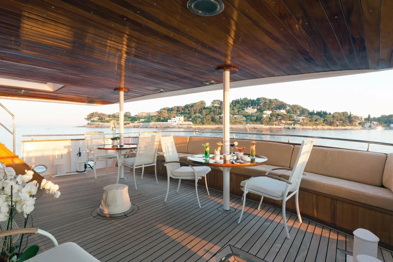a table with chairs and a large window overlooking a city aboard SHAHA Yacht for Sale