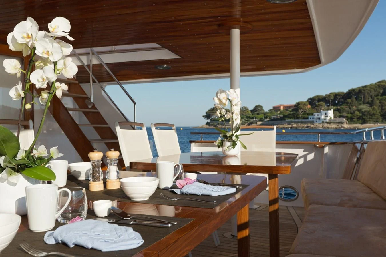 a table with cups and plates on it aboard SHAHA Yacht for Sale