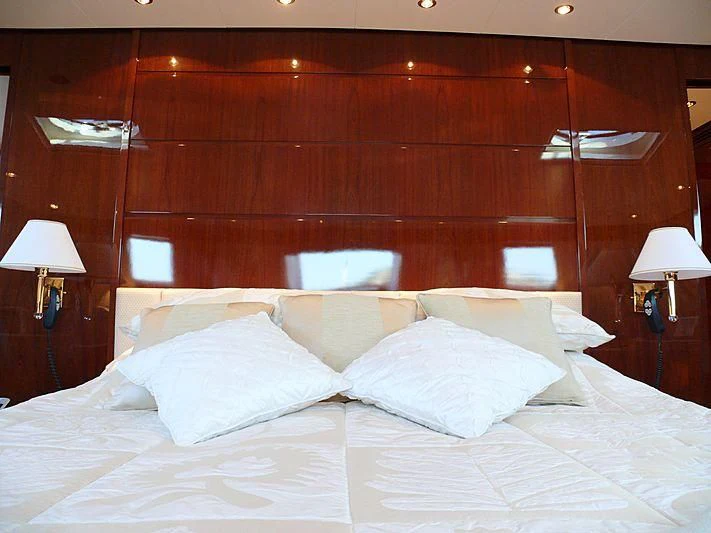 a bed with white sheets aboard ARGO B Yacht for Sale