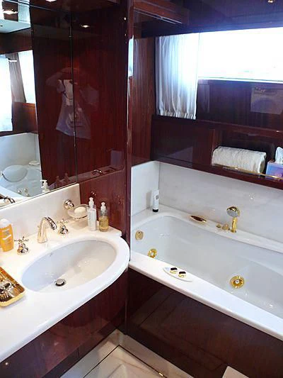 a bathroom with a tub sink and mirror aboard ARGO B Yacht for Sale