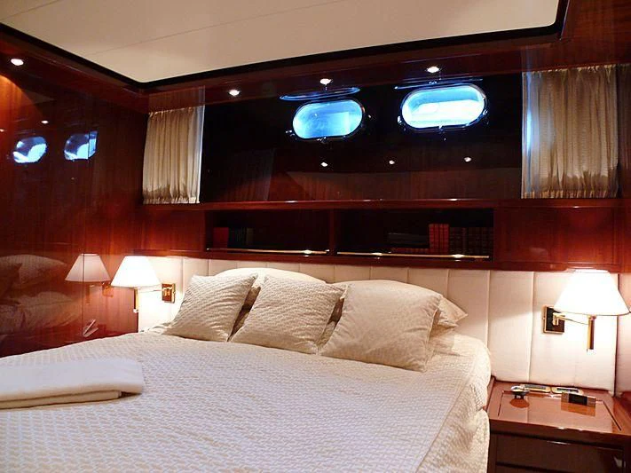 a bed with a white bed spread aboard ARGO B Yacht for Sale