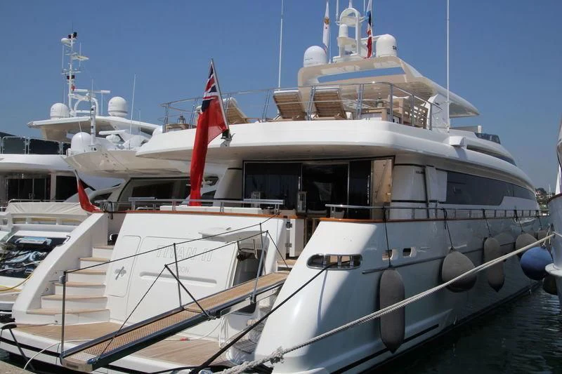 a large white boat with a red and white flag on it aboard ARGO B Yacht for Sale