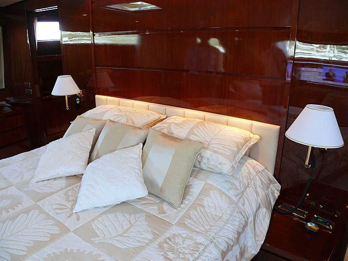 a bed with white sheets aboard ARGO B Yacht for Sale