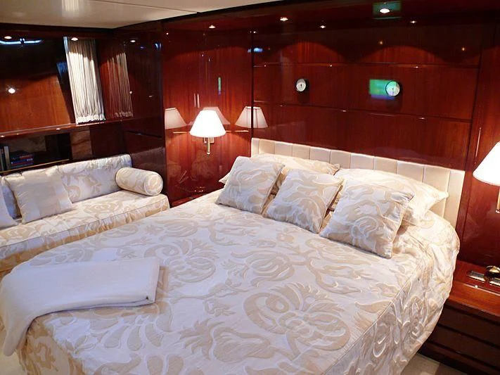 a room with a bed and a lamp aboard ARGO B Yacht for Sale