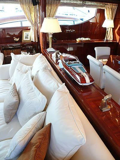 a bed with a white pillow and a lamp on it aboard ARGO B Yacht for Sale