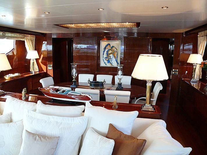 a room with a large bed and a table with lamps aboard ARGO B Yacht for Sale