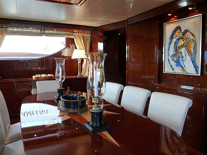 a table with a lamp and a vase with candles on it aboard ARGO B Yacht for Sale