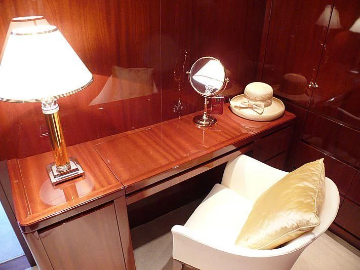 a hotel room with a table and lamps aboard ARGO B Yacht for Sale