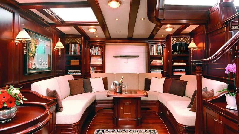 a living room with a large mirror aboard MARIA CATTIVA Yacht for Sale