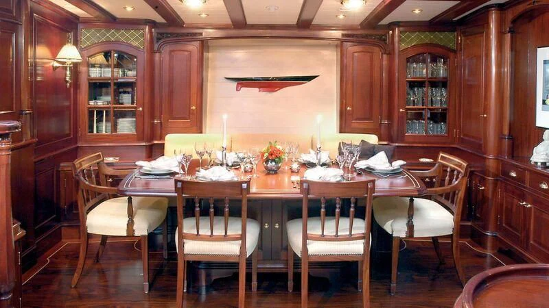a dining room with a table set aboard MARIA CATTIVA Yacht for Sale