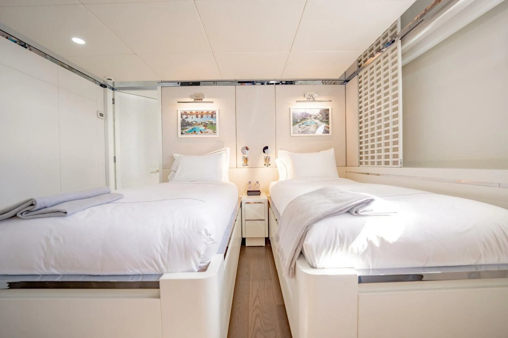 a room with white beds aboard BG Yacht for Sale
