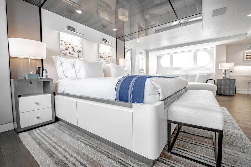 a bedroom with a bed and a table aboard BG Yacht for Sale